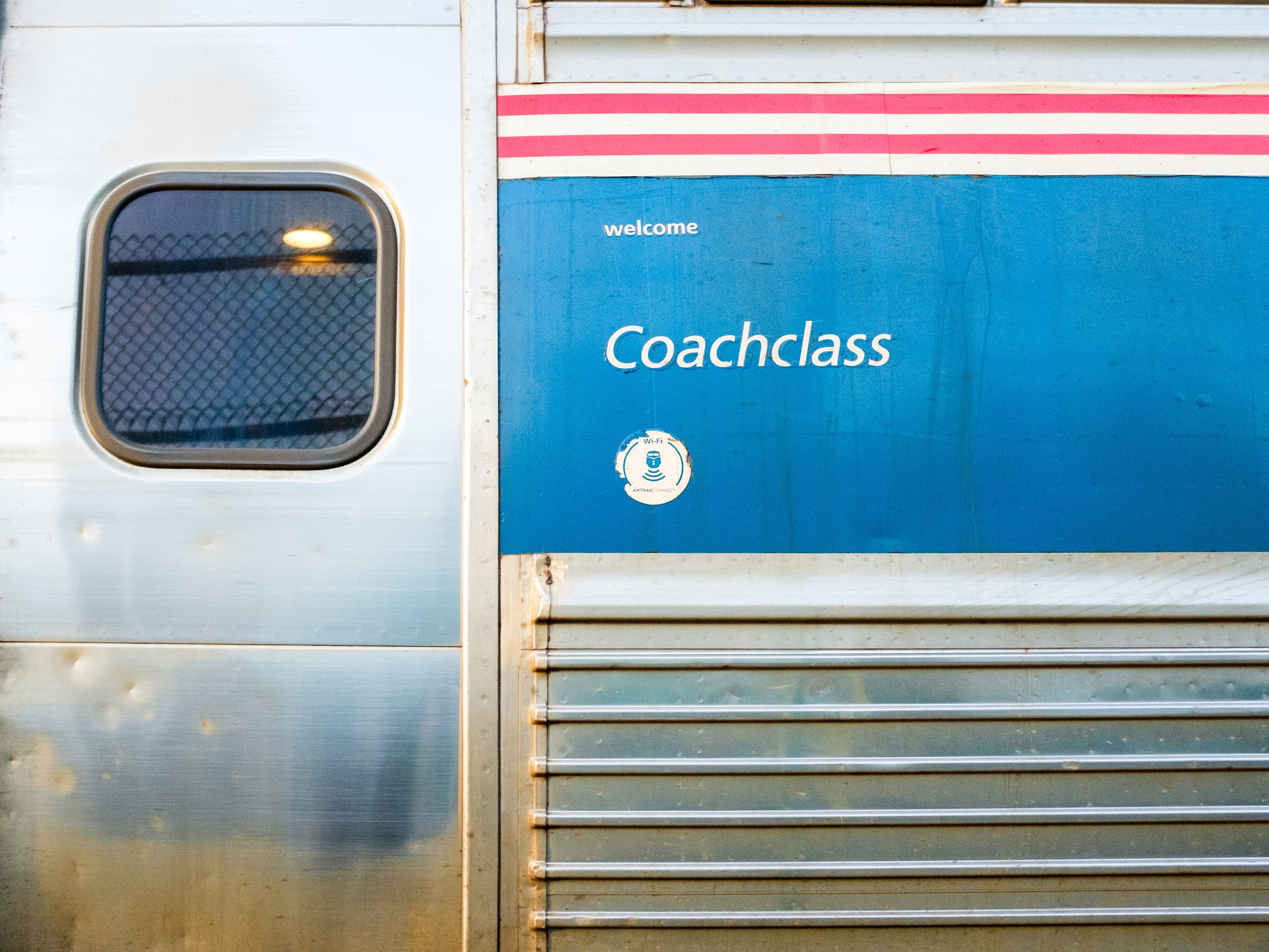 A close-up of a coach car's exterior on an Amtrak train