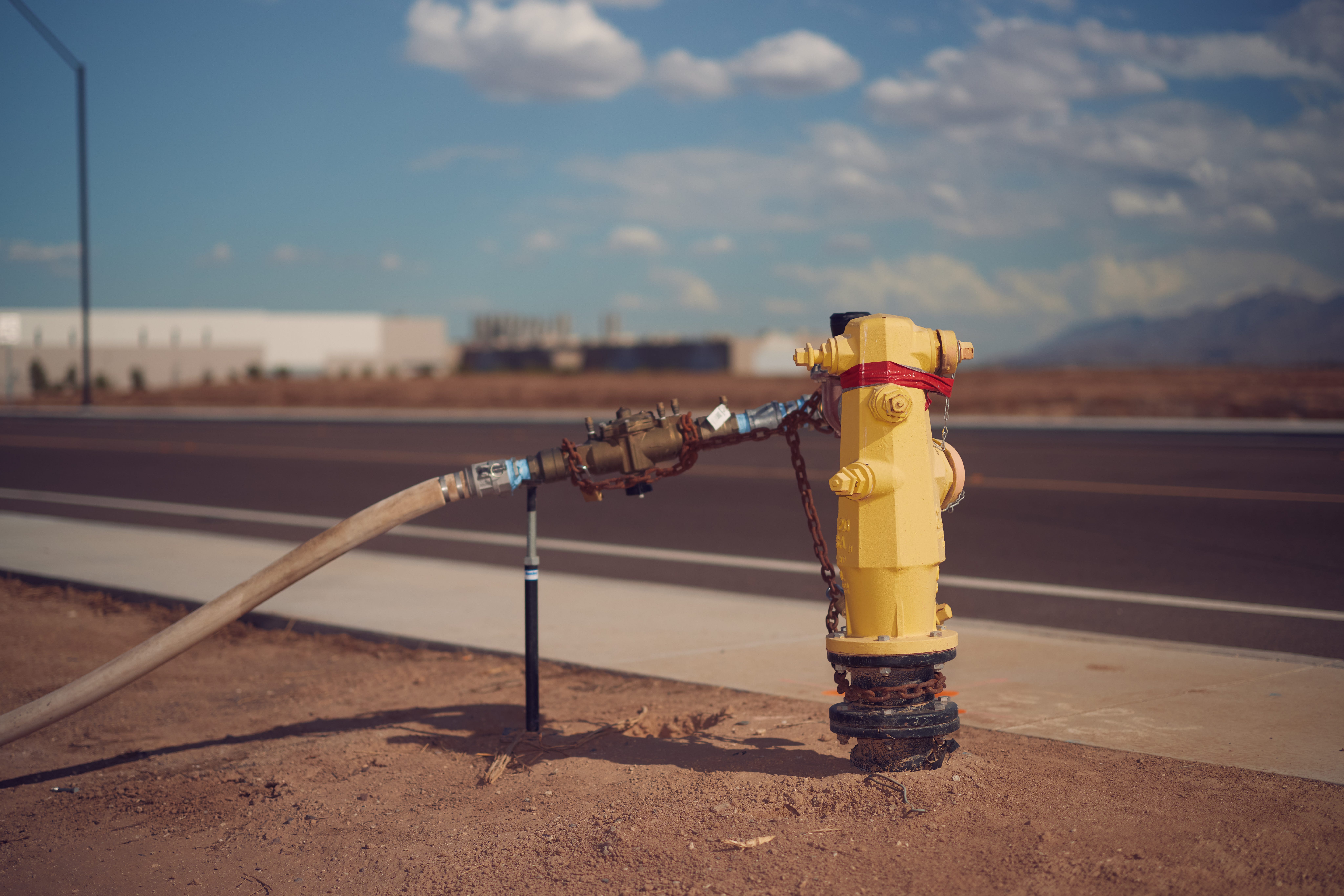A fire hydrant connected to a hose.