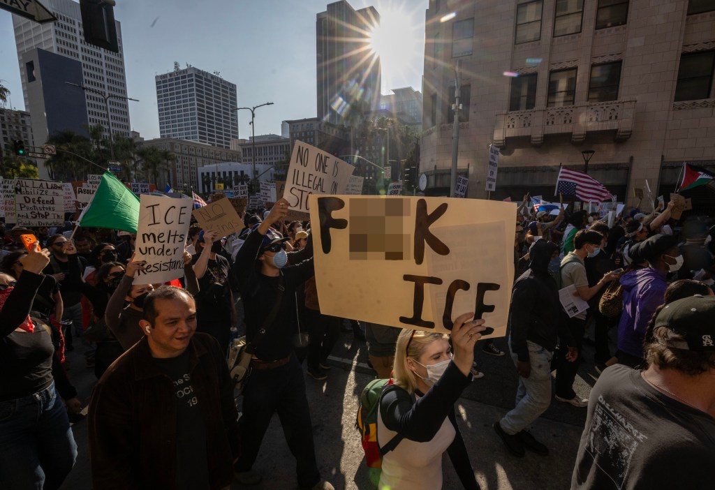 Protestors in Los Angeles march with signs.