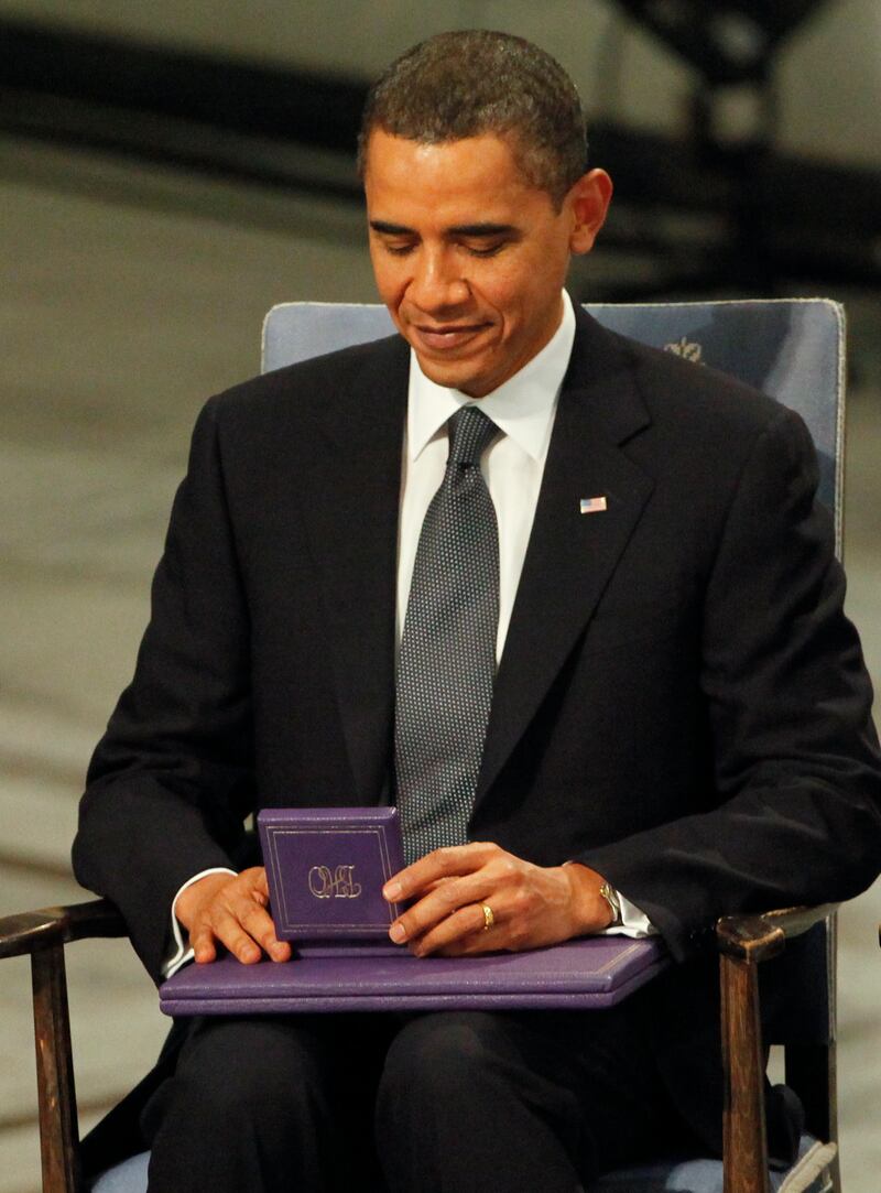 Nobel Peace Prize laureate U.S. President Barack Obama looks at his medal after
