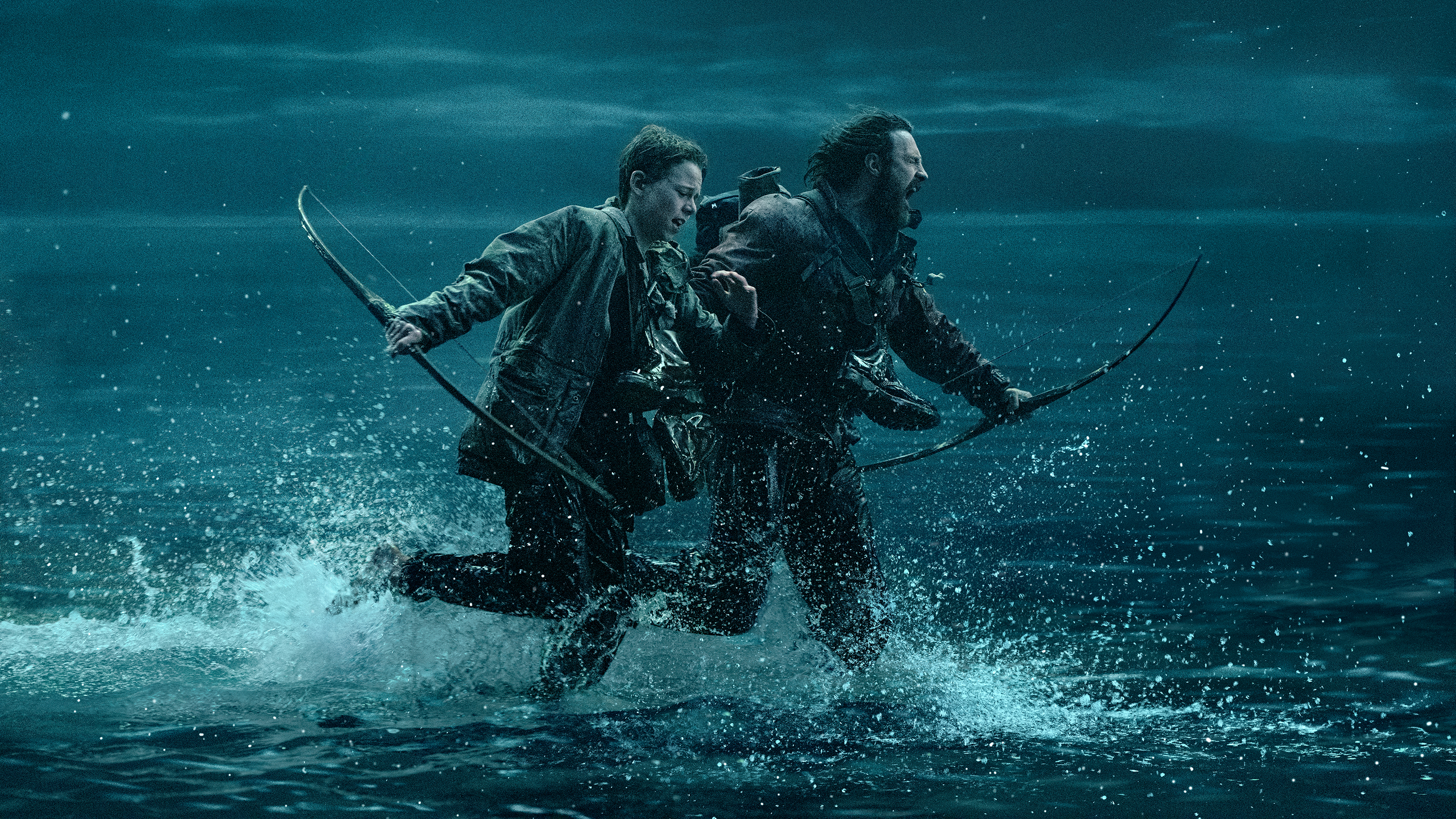 A still from 28 Years Later showing a man and a boy running
