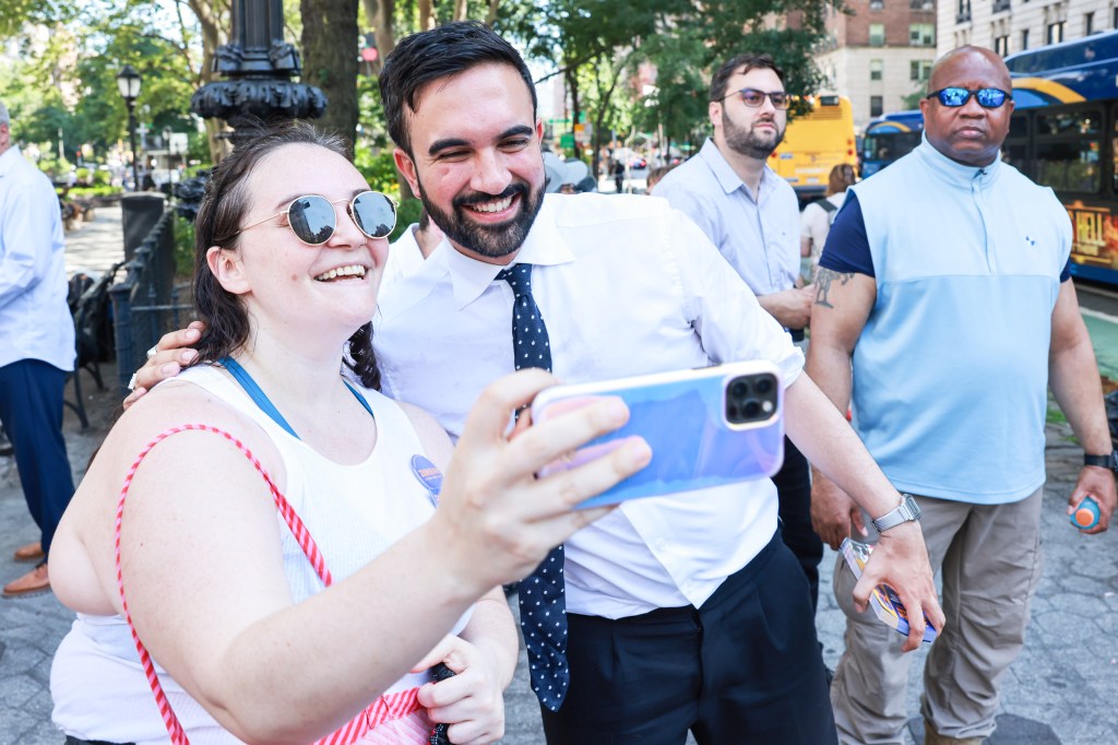 Mamdani taking a selfie with a primary voter in Manhattan on the morning of the primary.