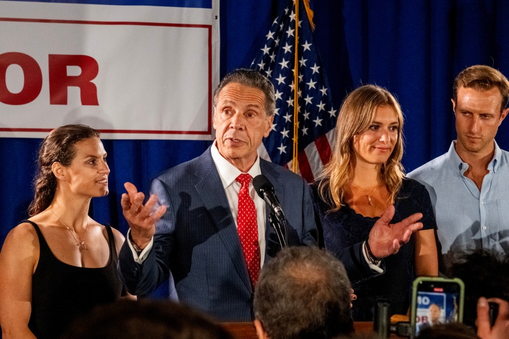 Former Governor Andrew Cuomo, flanked by daughters Michaela, Cara, and Mariah, along with son-in-law Tellef Lundgren, speaks to supporters at his election-night party at Carpenters Union Hall on June 24, 2025.
