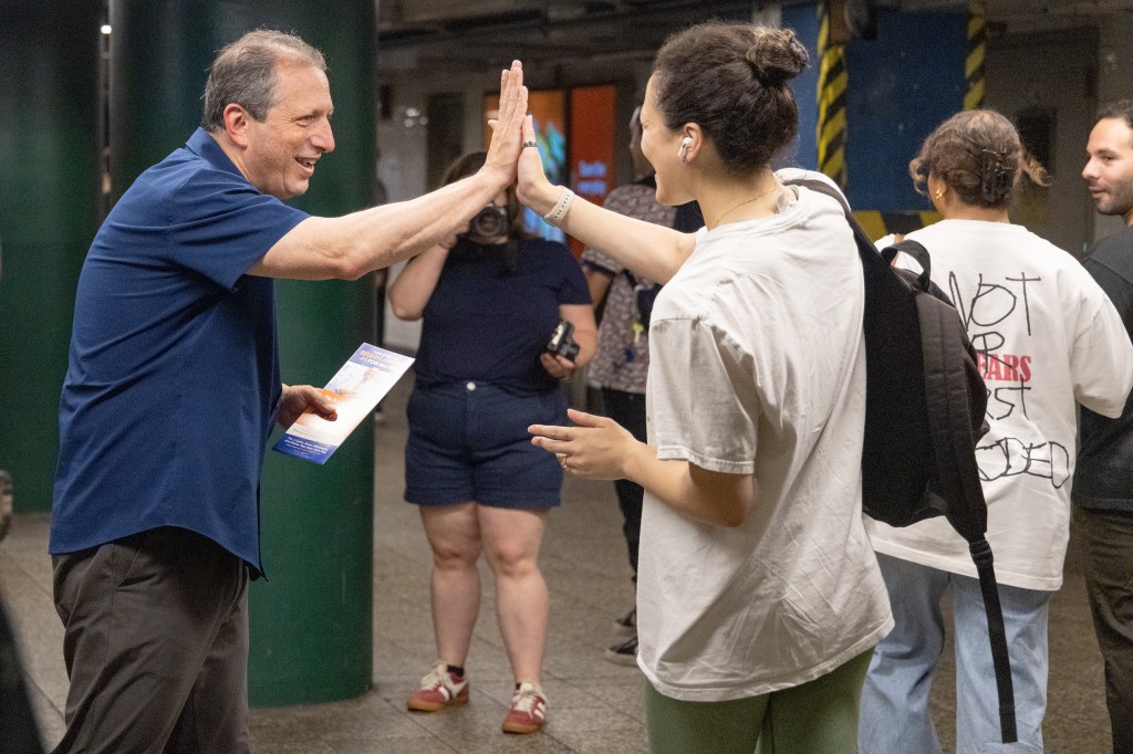 Lander greeting a voter in Brooklyn ahead of the primary.