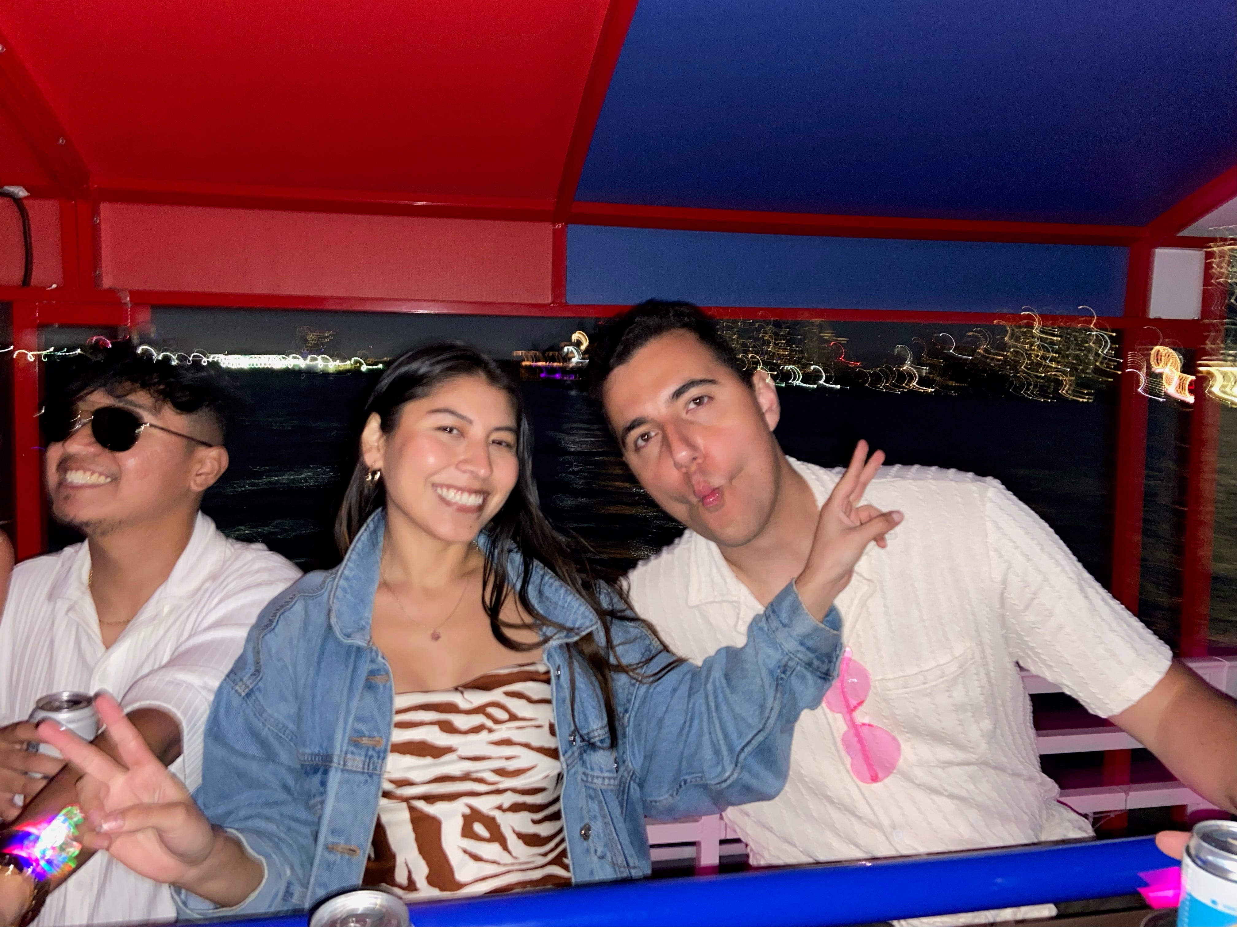Viviana Vazquez and Xavier Carrillo pose for the camera as they ride on a boat