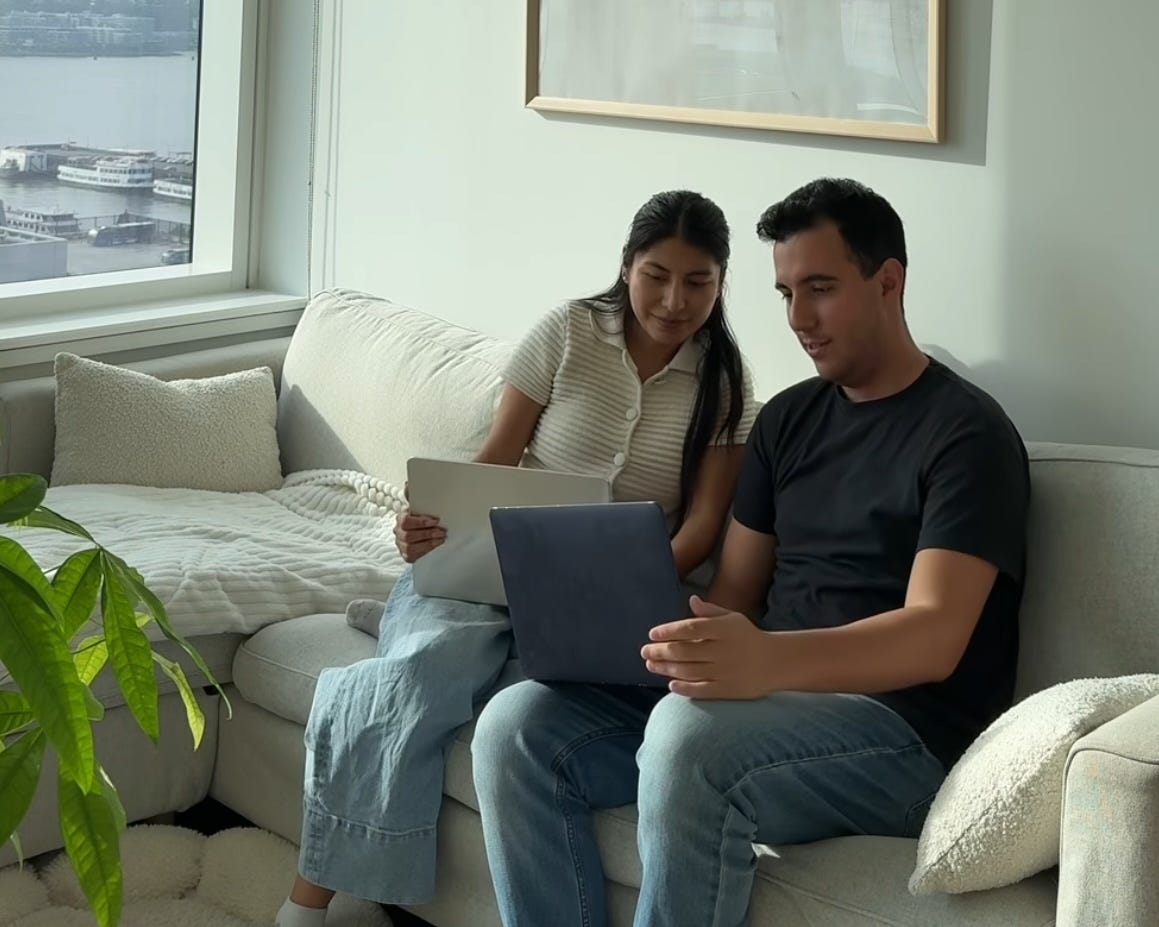 Viviana Vazquez and Xavier Carrillo sit on a couch as they look at their laptops