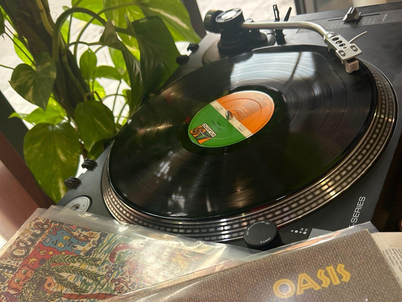 A record player with the corner of a vinyl of Roberta Flack's album,