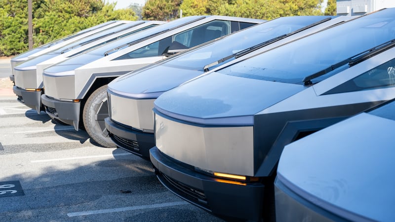 Line of multiple Tesla Cybertrucks at Tesla Motors dealership in Colma, California, December 6, 2024.