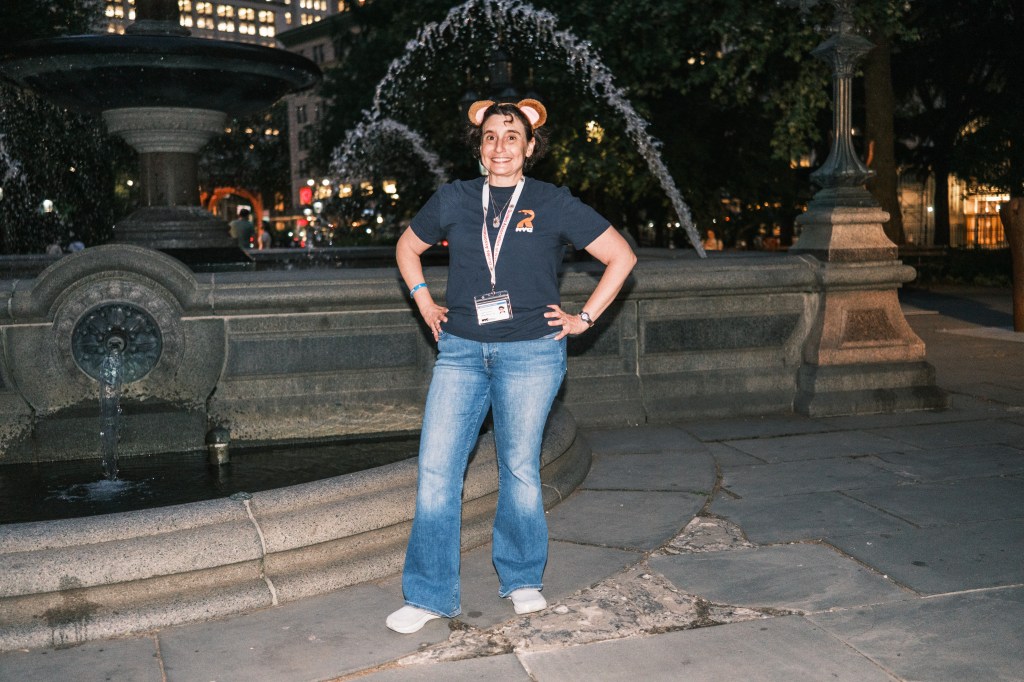 A woman wearing mouse ears gives a tour in lower Manhattan.