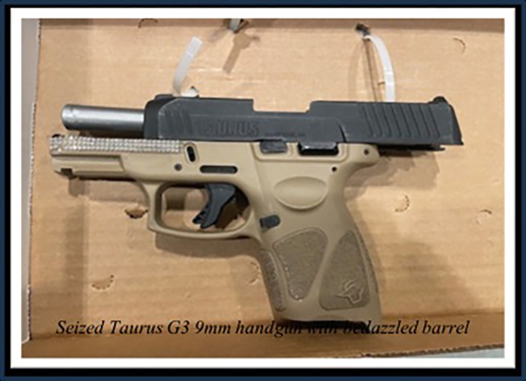Seized Taurus G3 9mm handgun with bedazzled barrel.