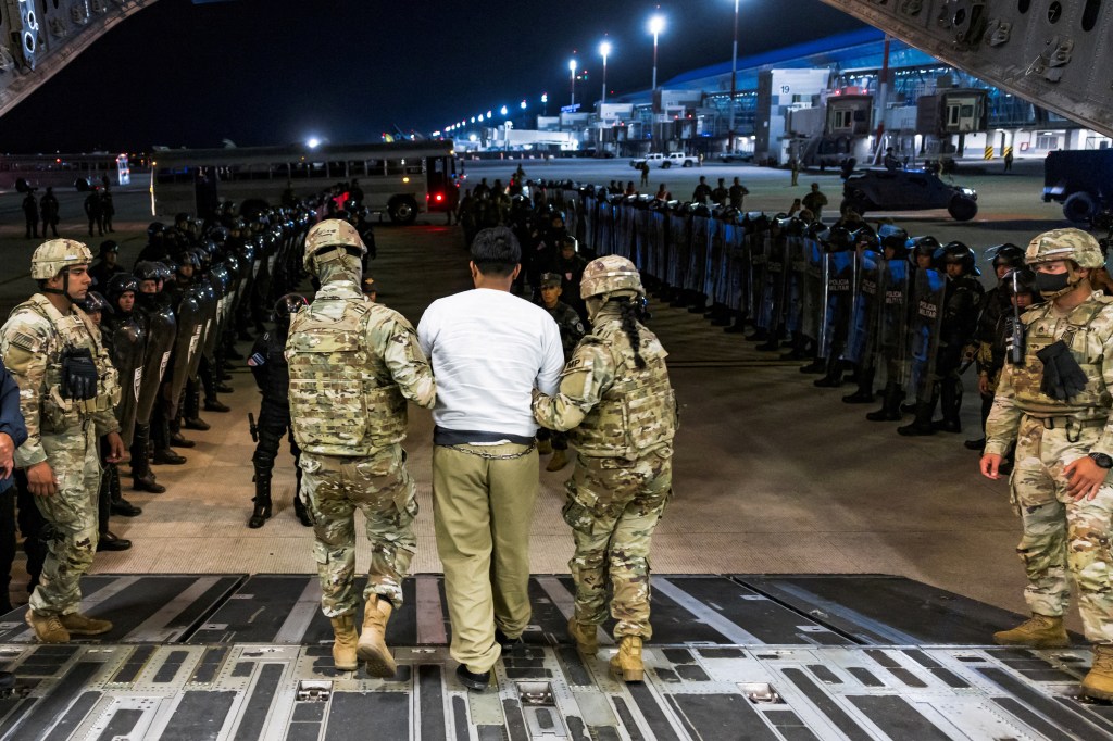 Alleged gang members being deported from the U.S. at an airport.
