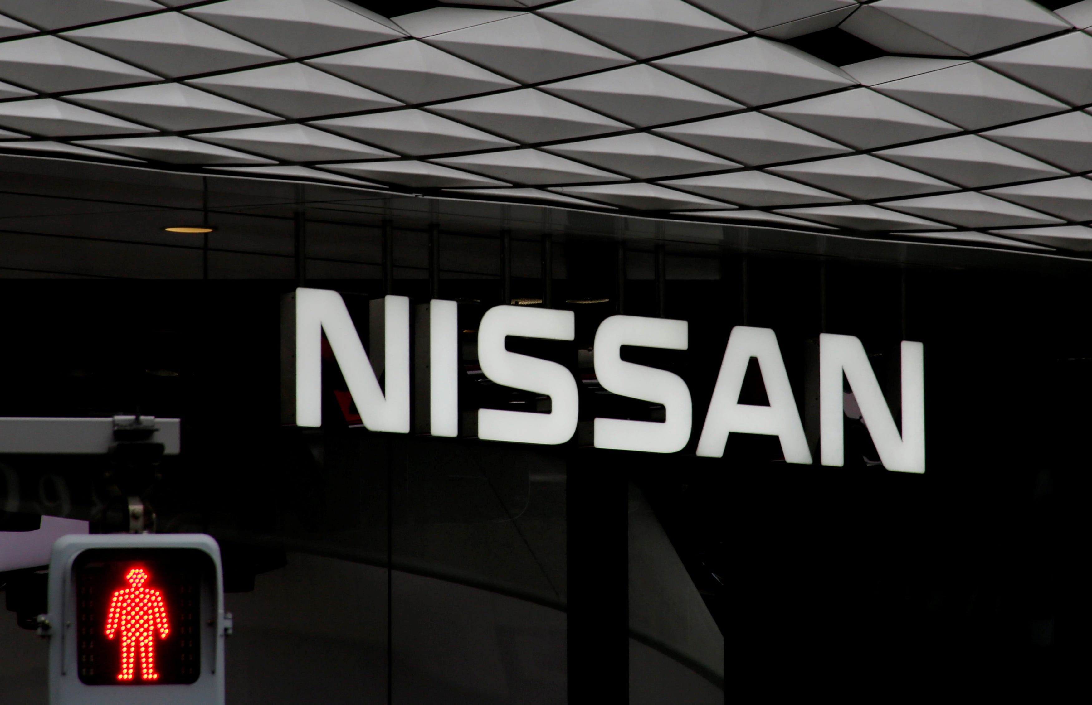 FILE PHOTO: The logo of Nissan Motor Co. is seen at its show room behind a traffic sign in Tokyo, Japan, February 12, 2019. REUTERS/Kim Kyung-hoon/File Photo