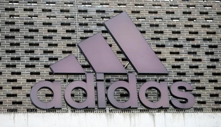 FILE PHOTO - The logo of Adidas is seen on an outlet store in Metzingen, Germany, June 16, 2017. REUTERS/Michaela Rehle