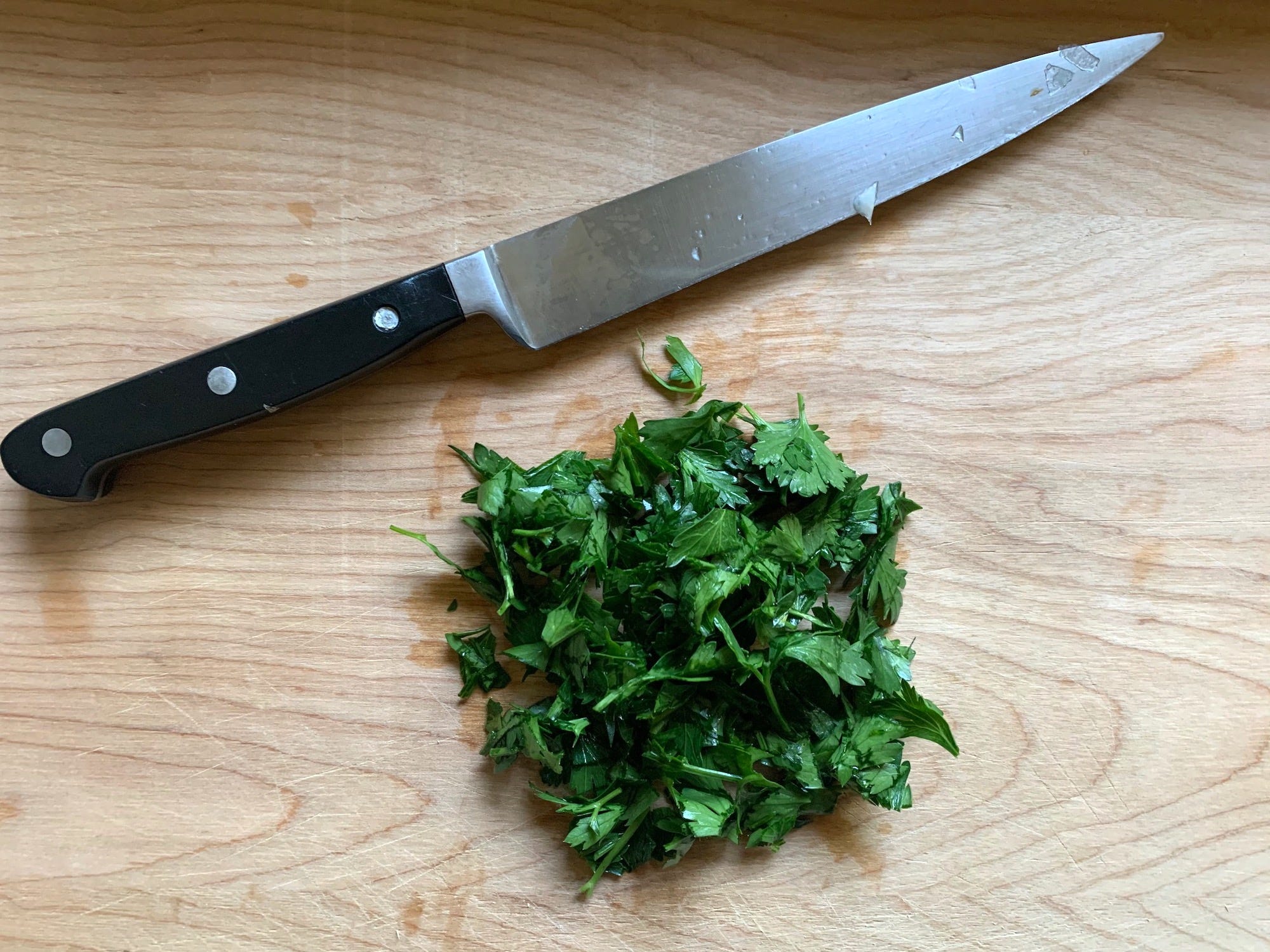 Chopped up parsley and a knife