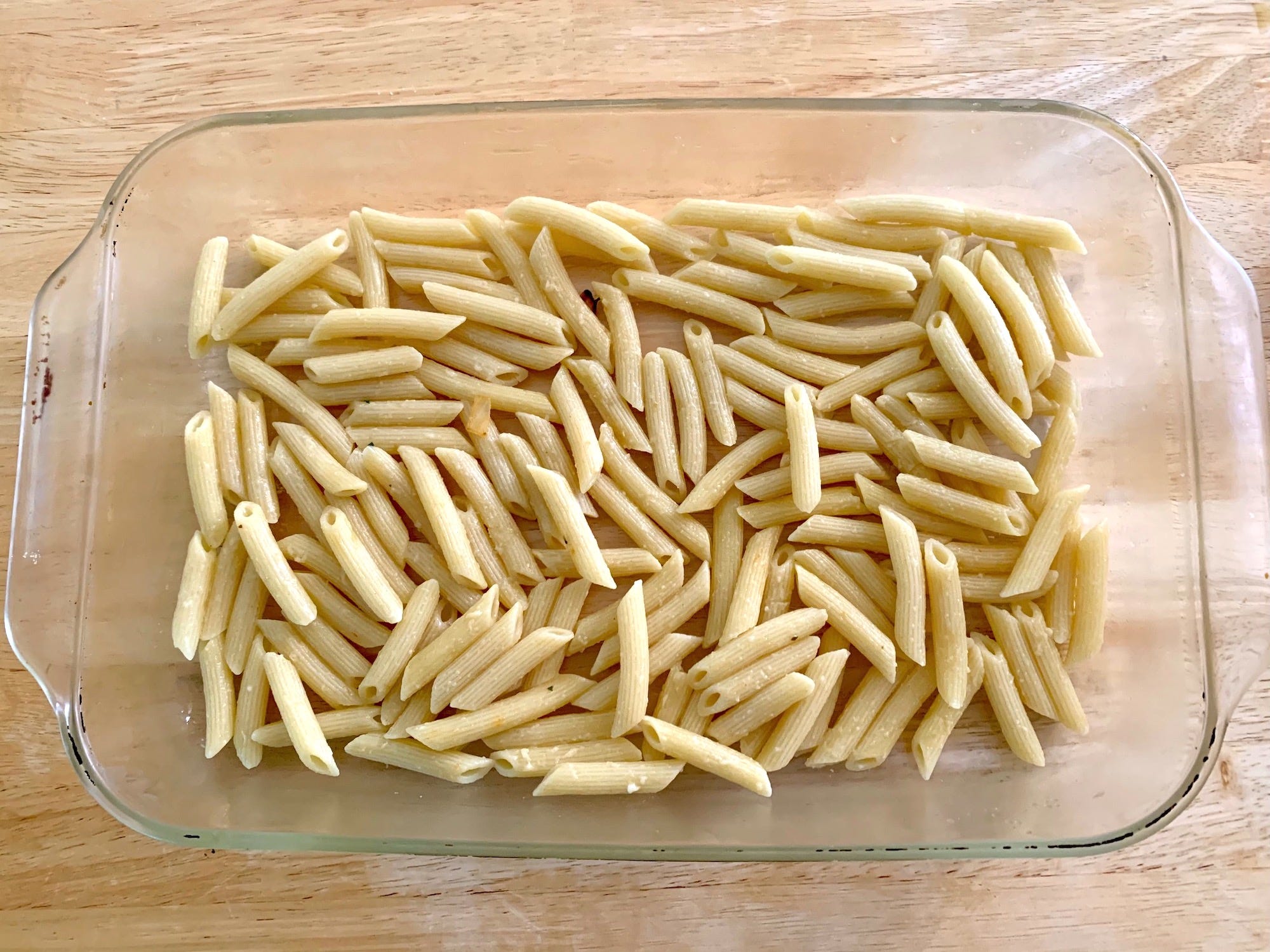 Cooked pasta on the bottom of a glass baking dish