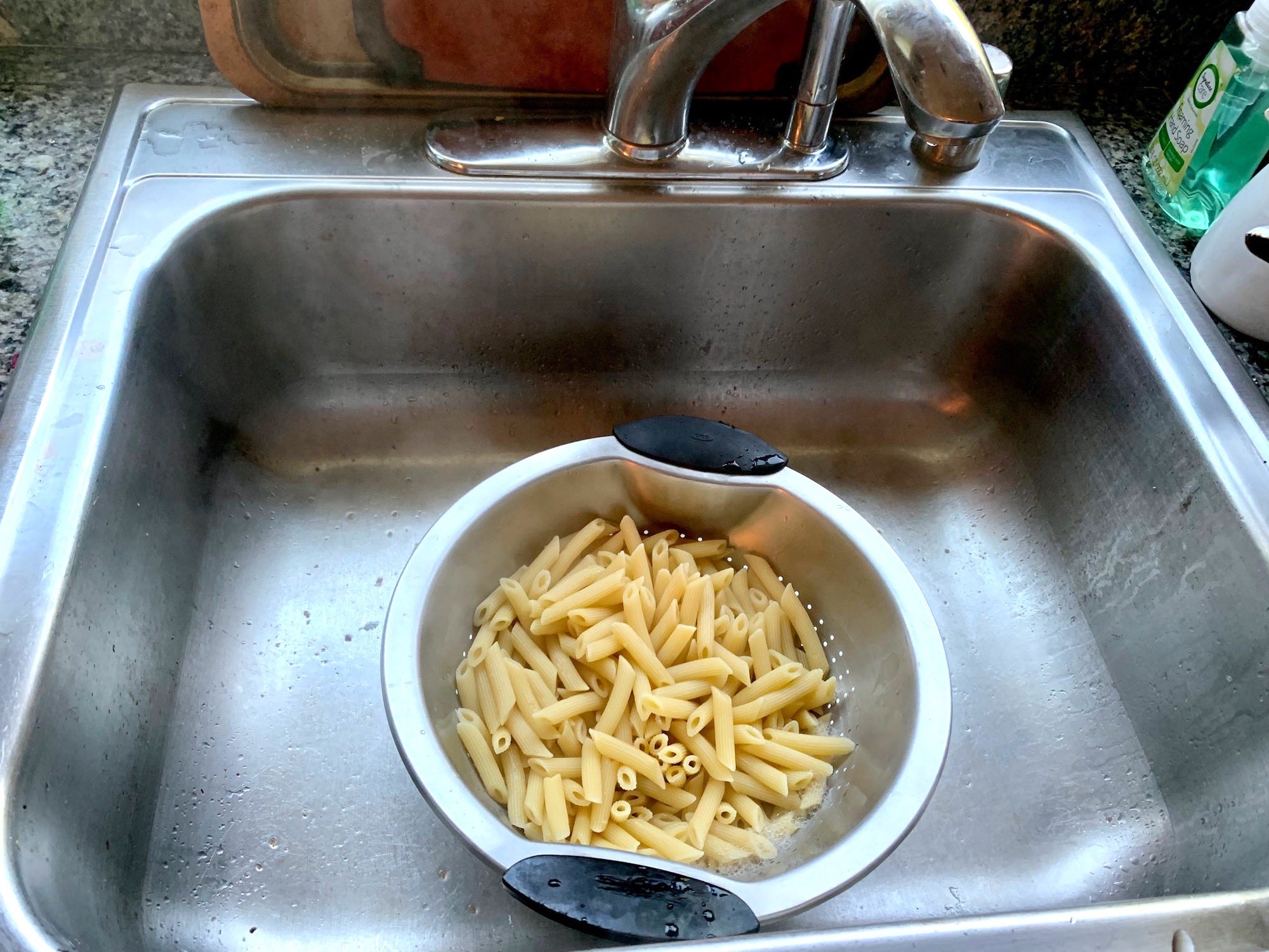 Cooked pasta in a colander in the sink