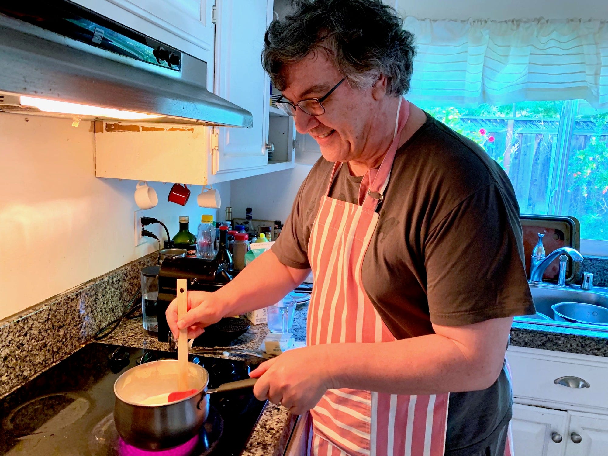 Greek dad cooking pastitio sauce