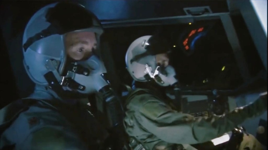 Screengrab of two pilots in a B-2 Spirit Stealth Bomber cockpit.
