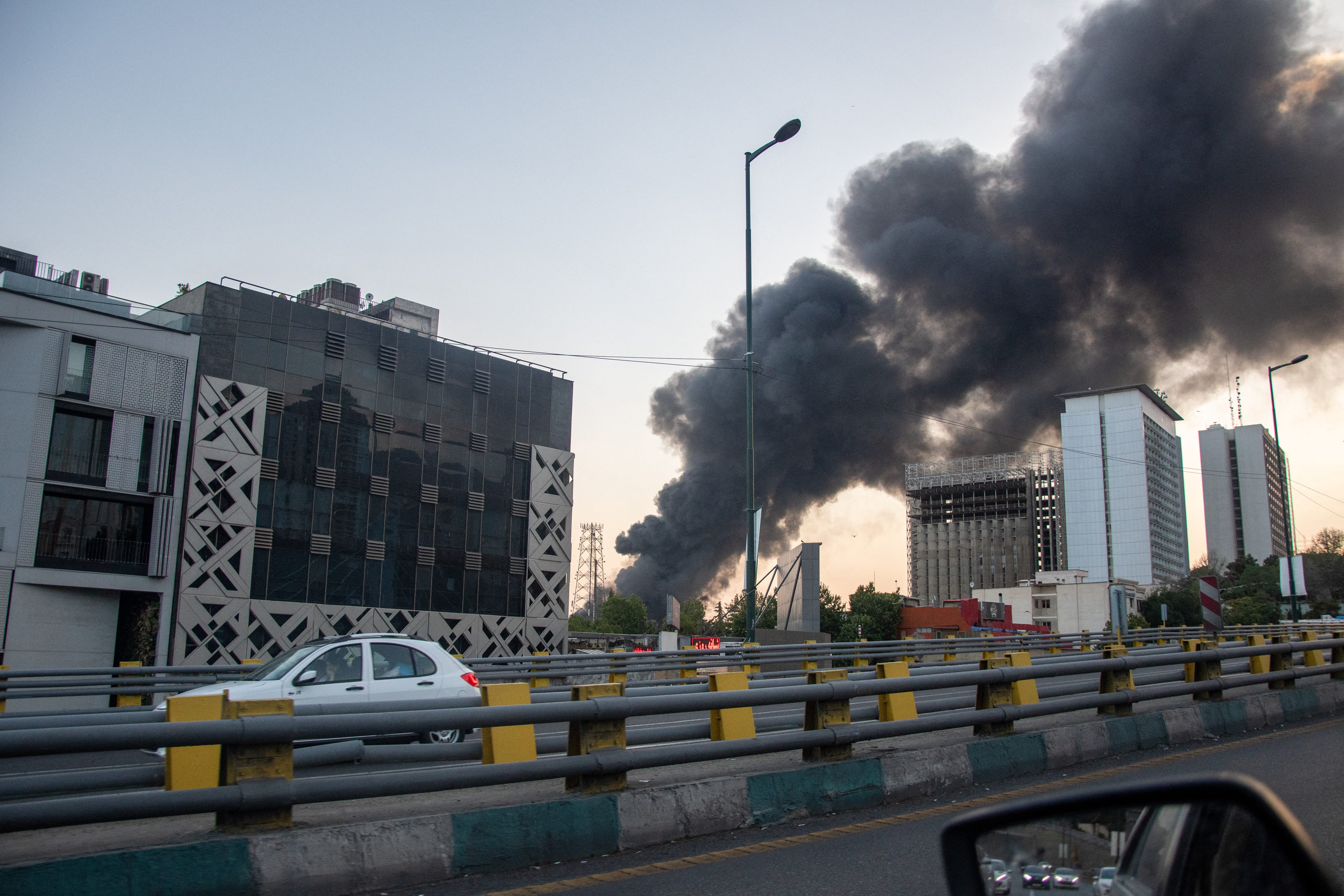 Smoke rises from the rubble of an Iranian state media building in Tehran after an Israeli airstrike.