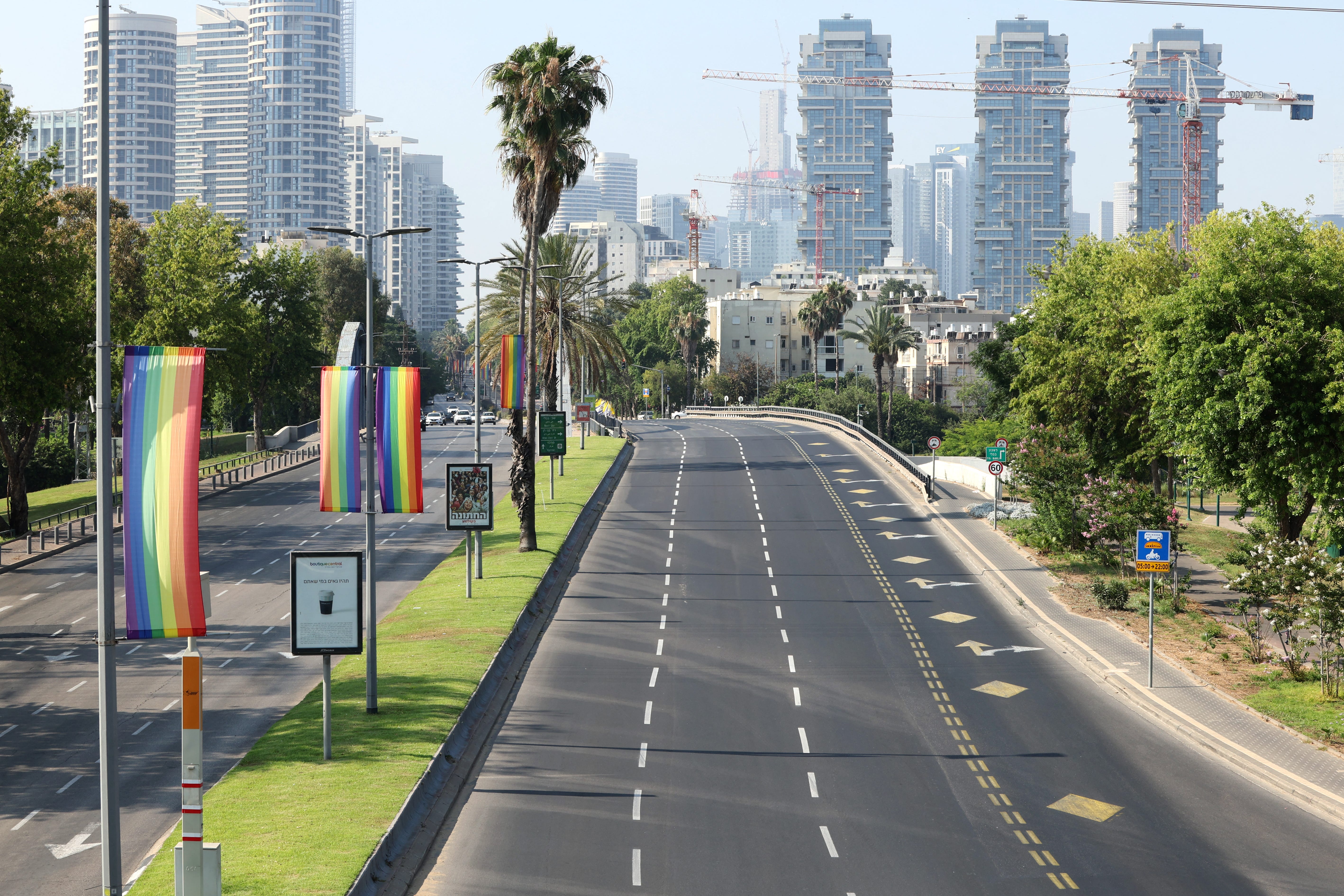 Empty streets in Tel Aviv with Pride flags.