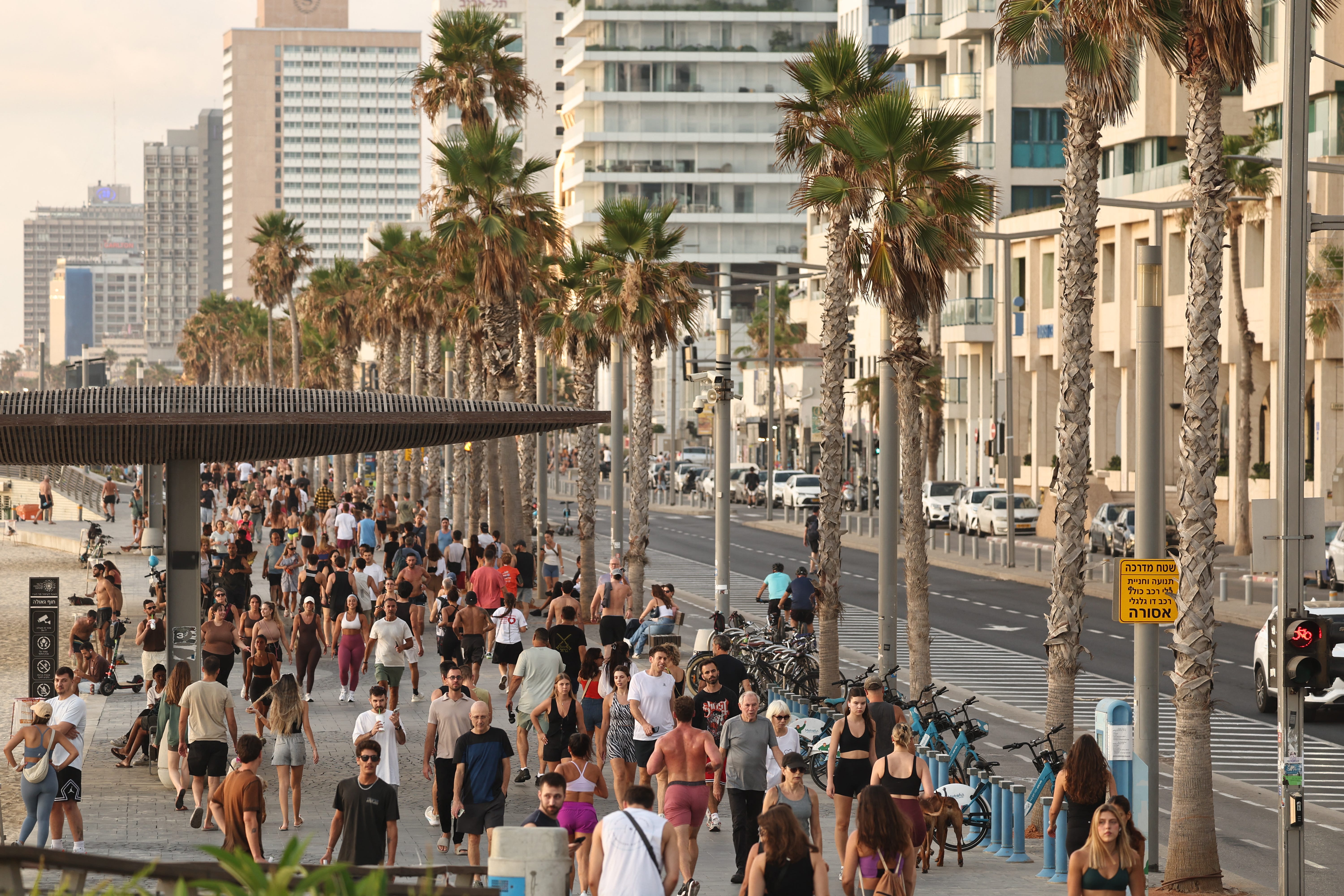 People walk on the promenade in Tel Aviv after a ceasefire between Israel and Iran.
