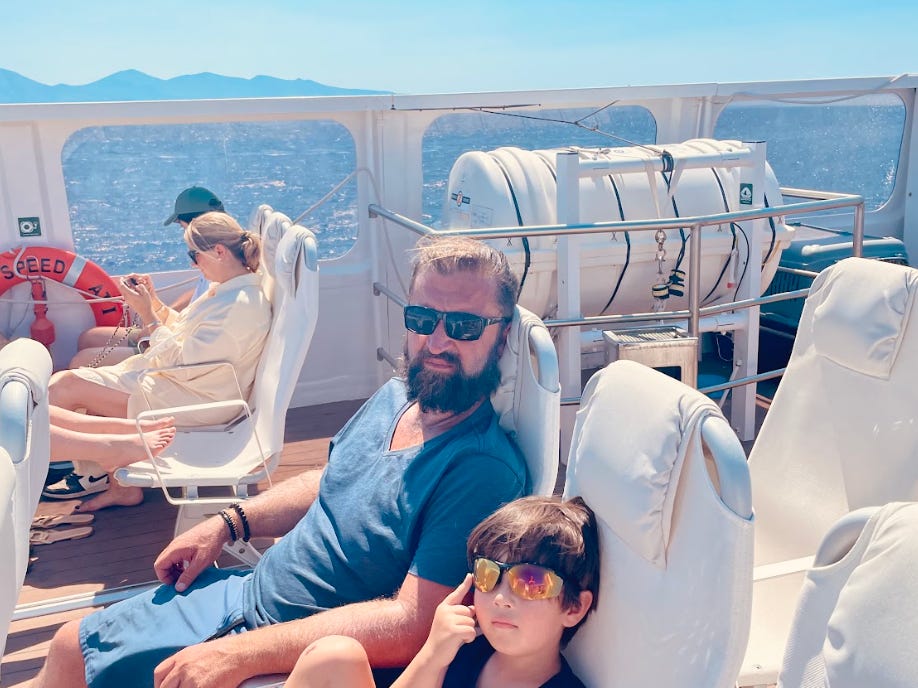 The writer's husband and son on a ferry in Hydra.