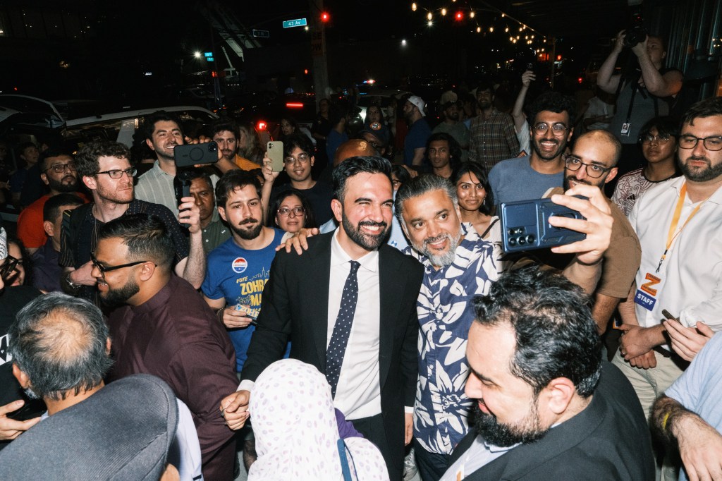 Zohran Mamdani greets supporters at a campaign event.
