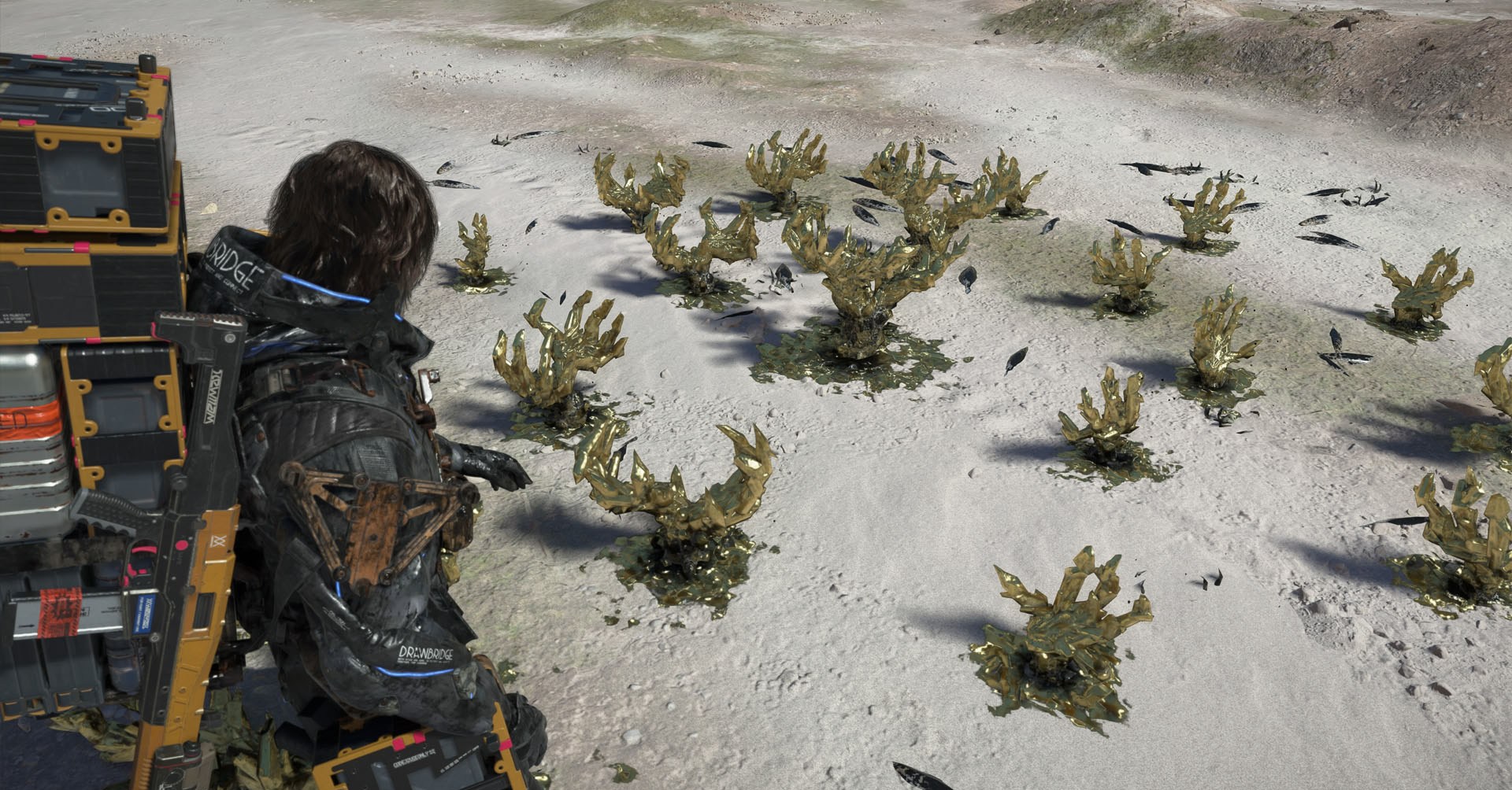 A Death Stranding 2 screenshot showing the character looking at golden crystals that look like claws.