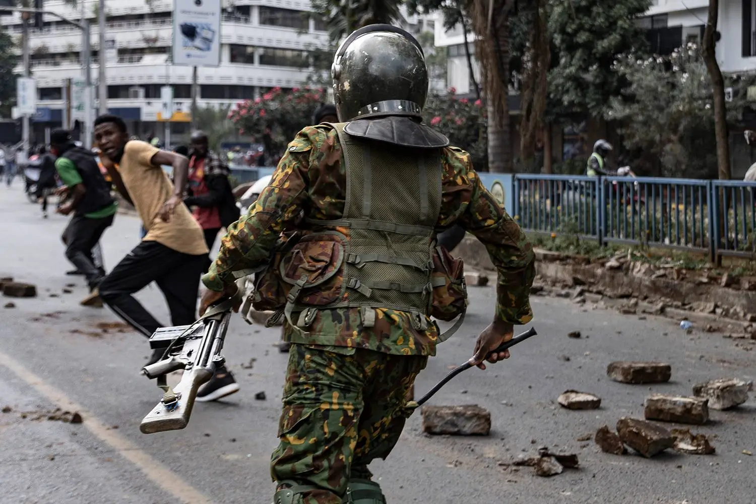 Protesters run from the police during a demonstration marking the first anniversary of the 2024 anti-government protests that left more than 60 people dead, seen in Nairobi, Kenya, on June 25. At least 16 people have been killed in this week’s protests so far, according to human rights group Amnesty Kenya.