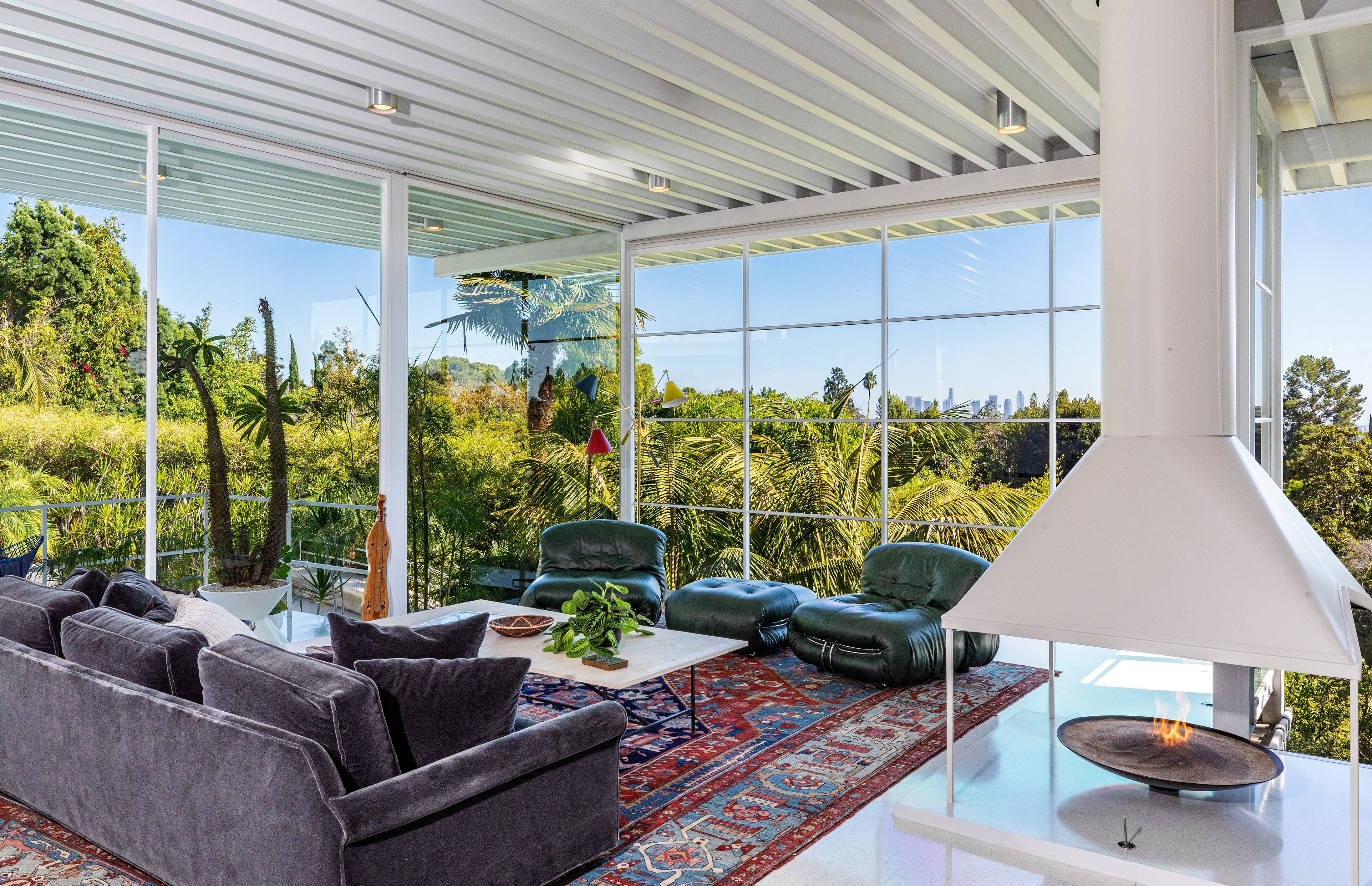 An image of a living room with floor to ceiling windows. 