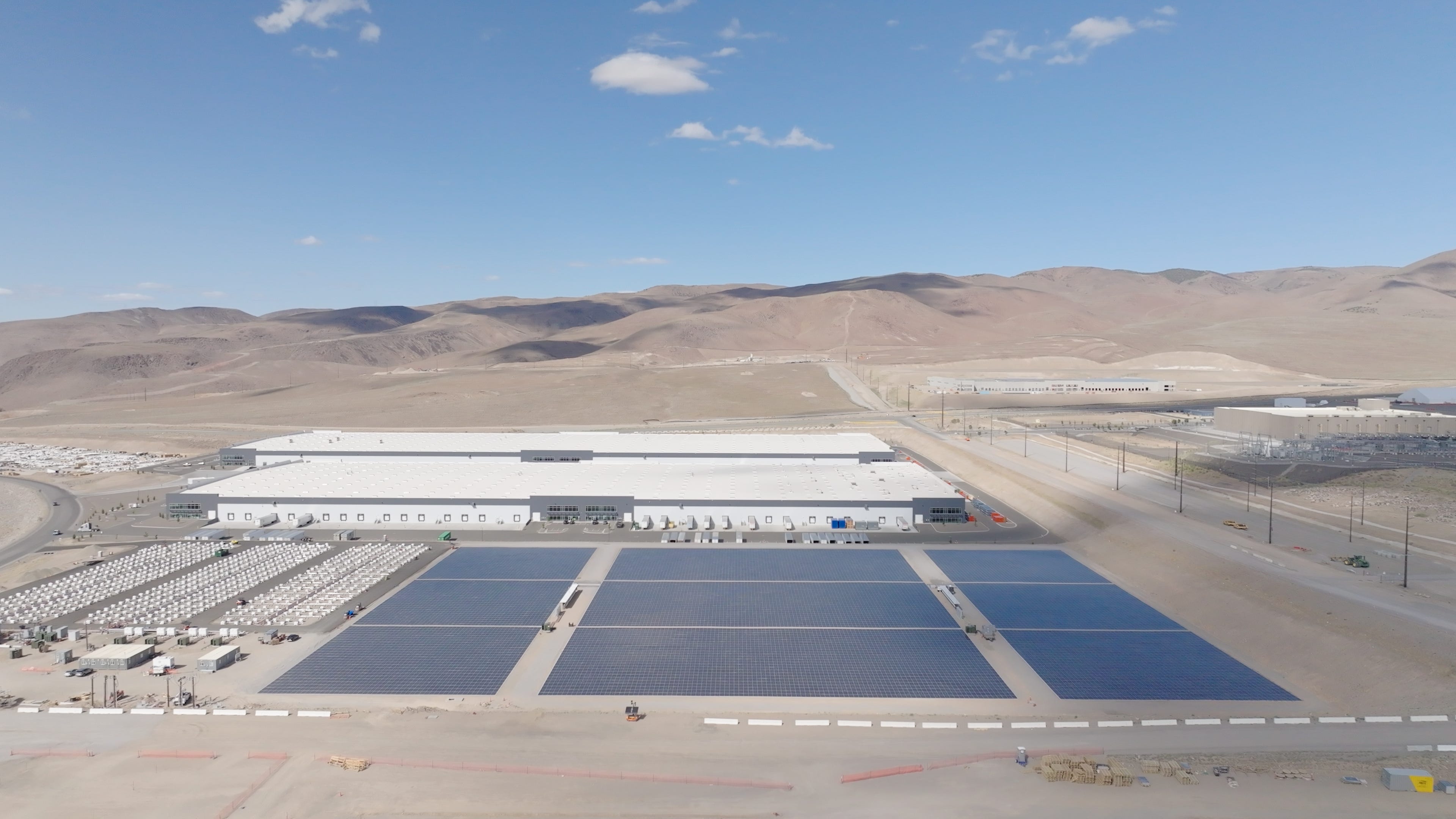 Redwood Materials campus in Nevada, with its energy storage system on the left, a solar array in the center and a Google data center on the far right