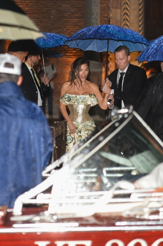 Lauren Sanchez is seen being escorted to her boat in Venice after leaving her pre-wedding party under a heavy storm