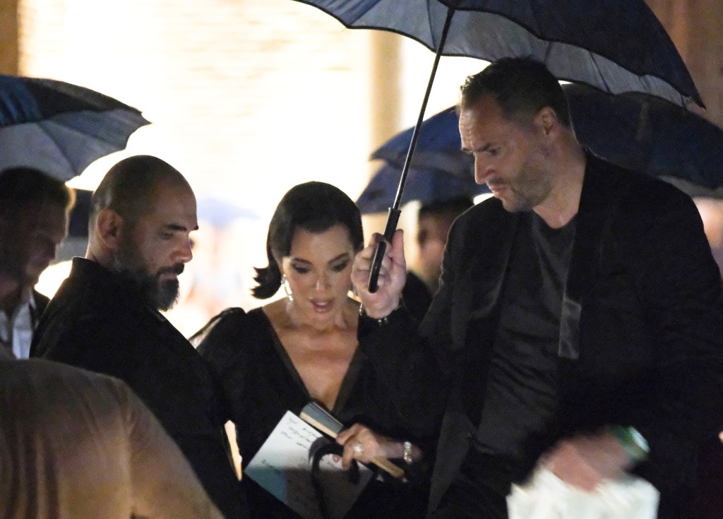Kris Jenner and Corey Gamble are spotted leaving Jeff Bezos and Lauren Sánchez's pre-wedding party during a crazy rainstorm in Venice