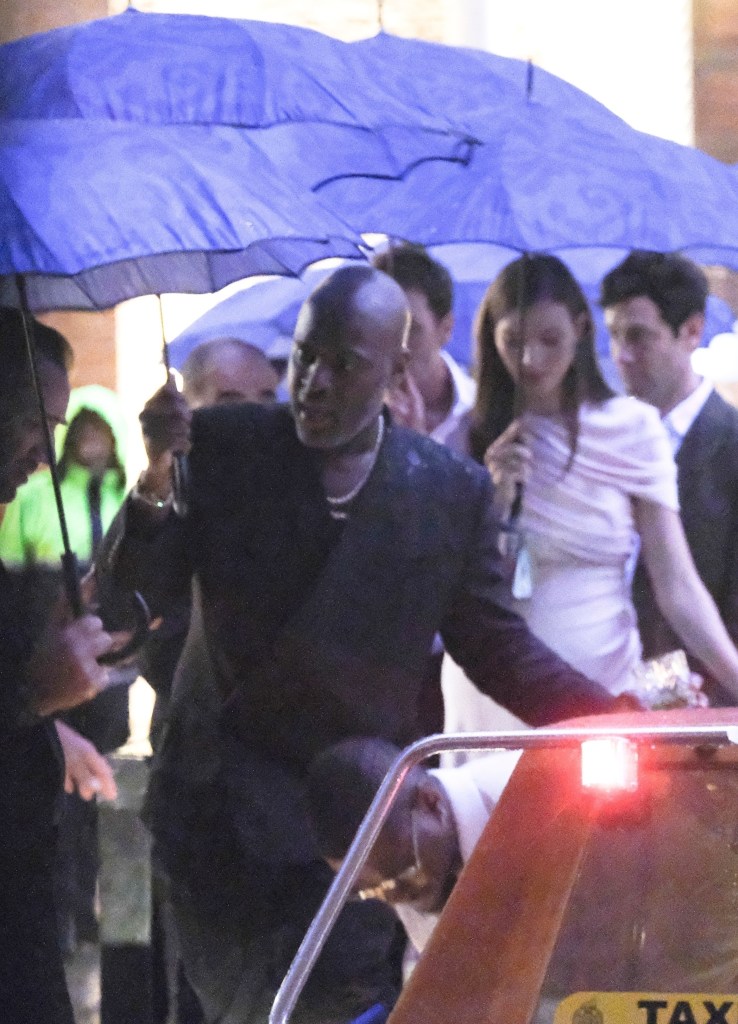 Kris Jenner and Corey Gamble are spotted leaving Jeff Bezos and Lauren Sánchez's pre-wedding party during a crazy rainstorm in Venice