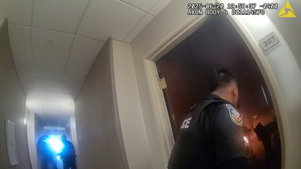 Lyndon Police Officer Yeng Xiong rushes into the burning hotel room to extinguish the fire on June 20, 2025.