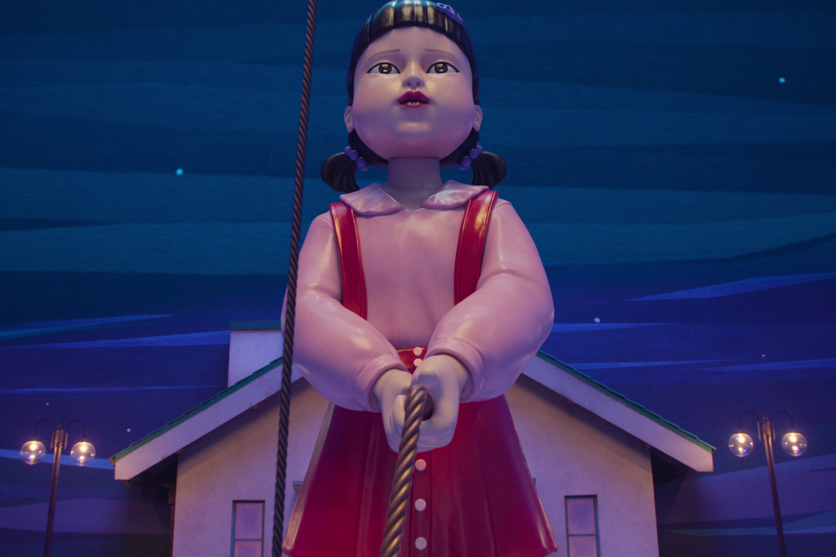 A doll holding a metal rope in "Squid Game" season three.