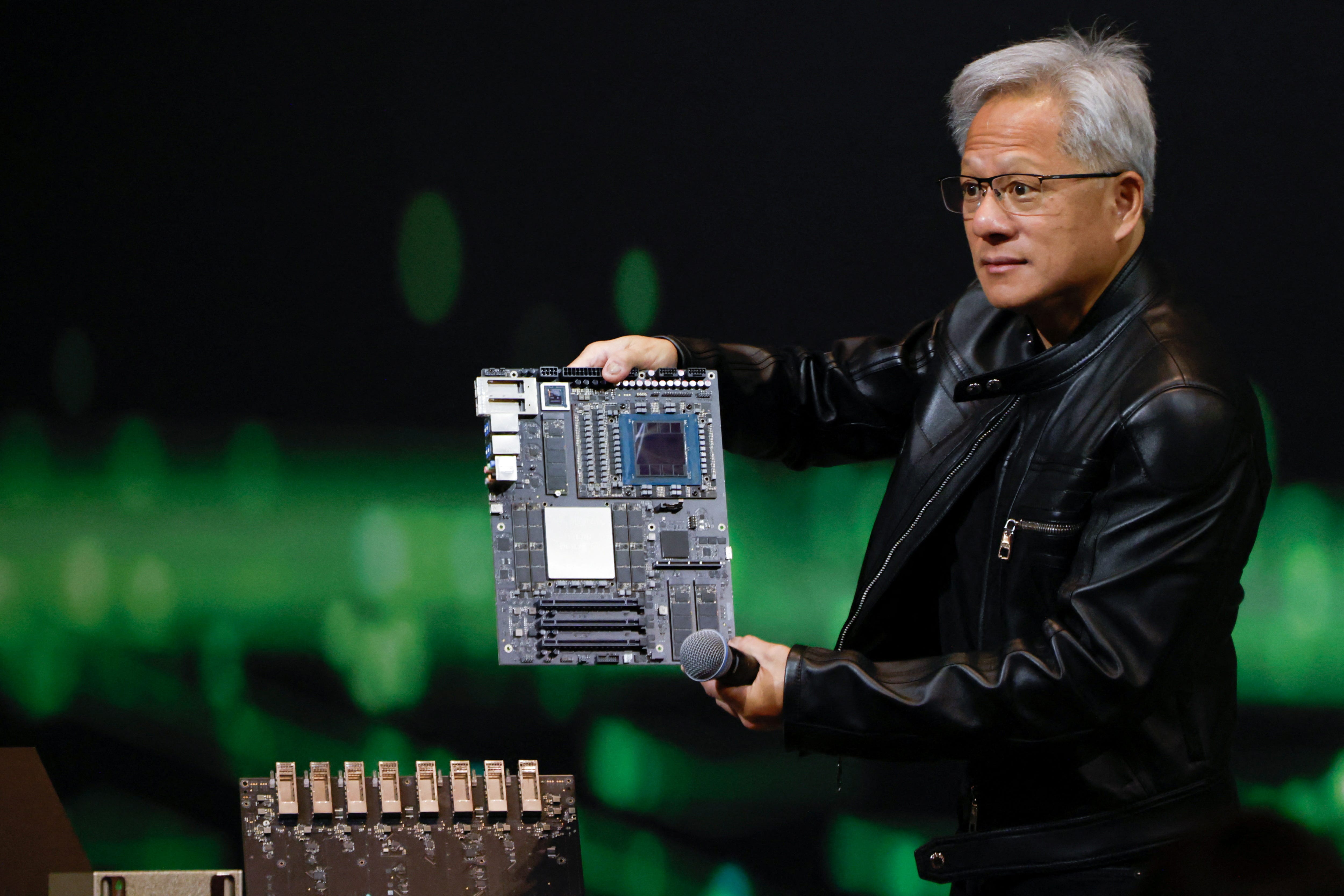 Nvidia's CEO, Jensen Huang, showing off products from the tech company.