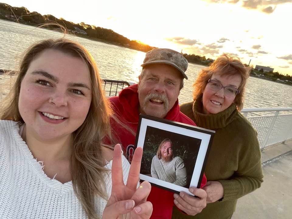Michele Morgan Bolton's family holding a picture of Alex