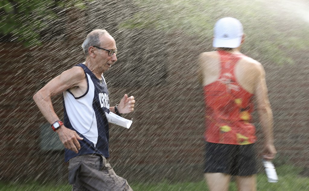  David Frisone, 80, runs through a sprinkler on the course of his weekly 5K at Eisenhower Park in East Meadow, N.Y.
