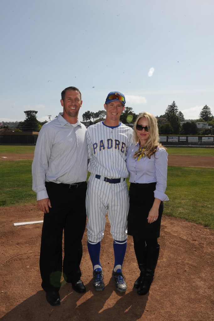 Calvin Riley with his parents at a baseball field.