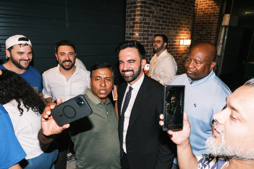 Zohran Mamdani greets supporters at a campaign event.