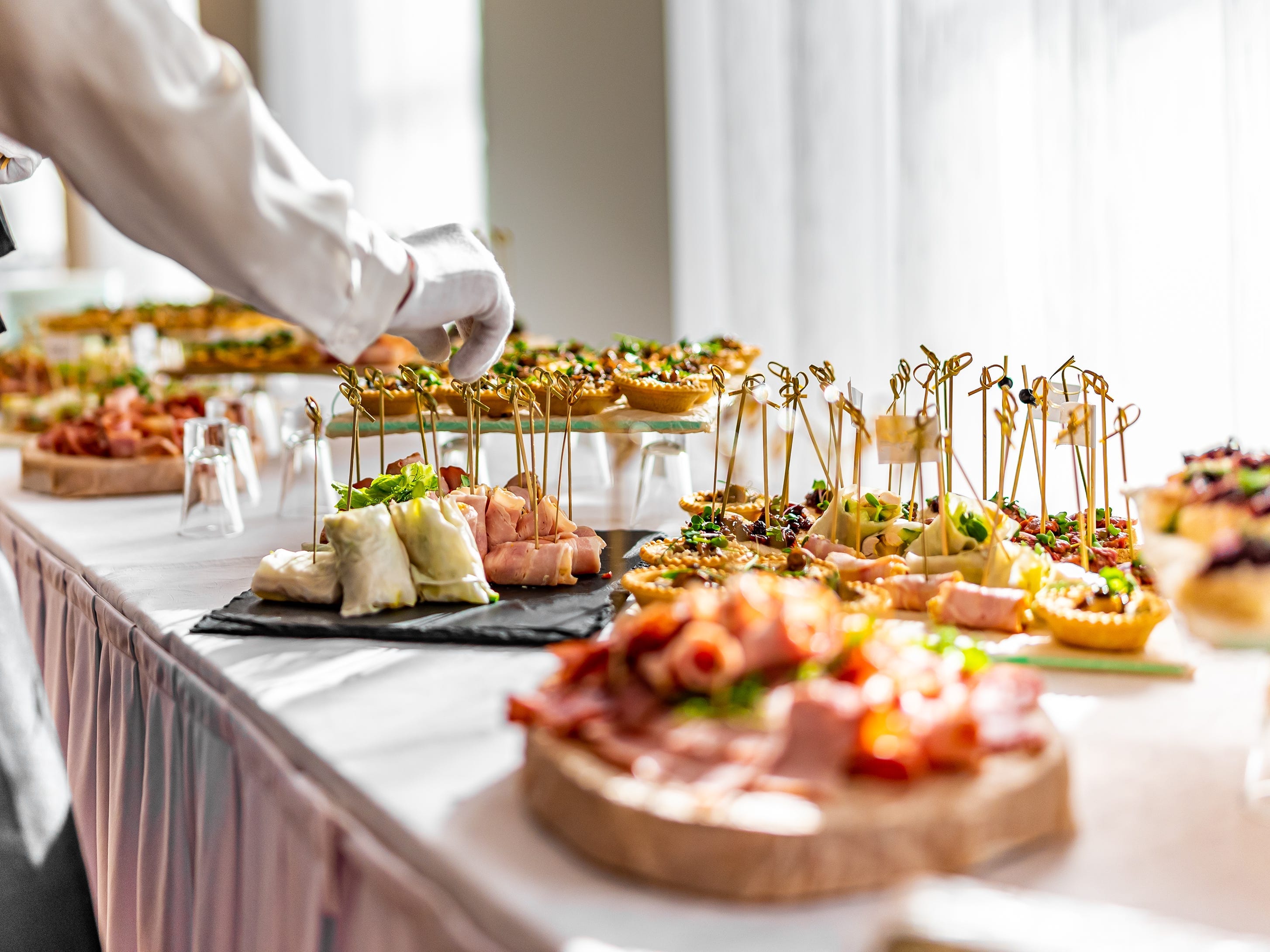 plates of appetizers with toothpicks on a table