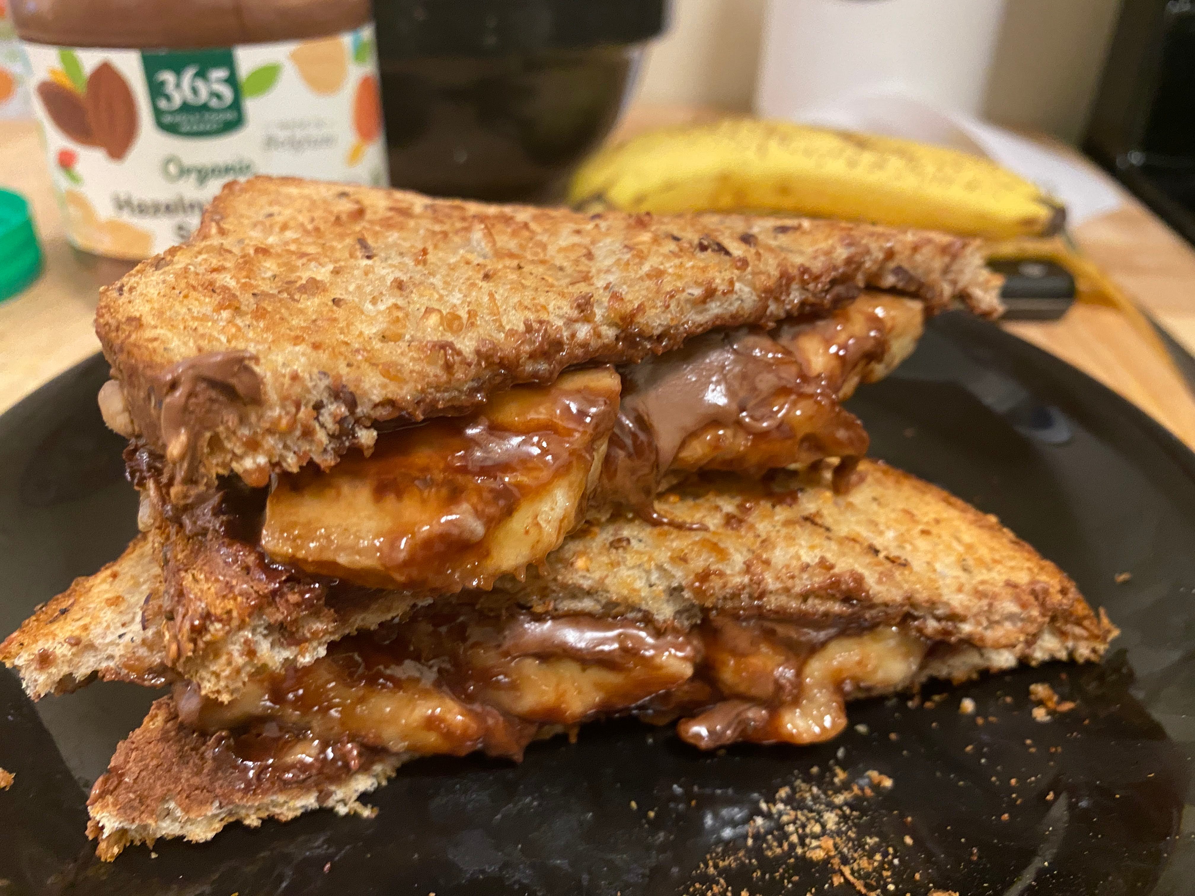 A photo of a nutella sandwich on a plate