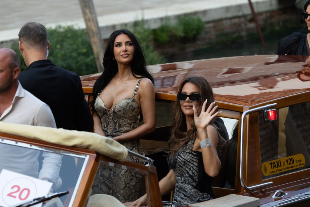 Kim Kardashian in a snake patterned dress, Khloe Kardashian in a black striped  gown.