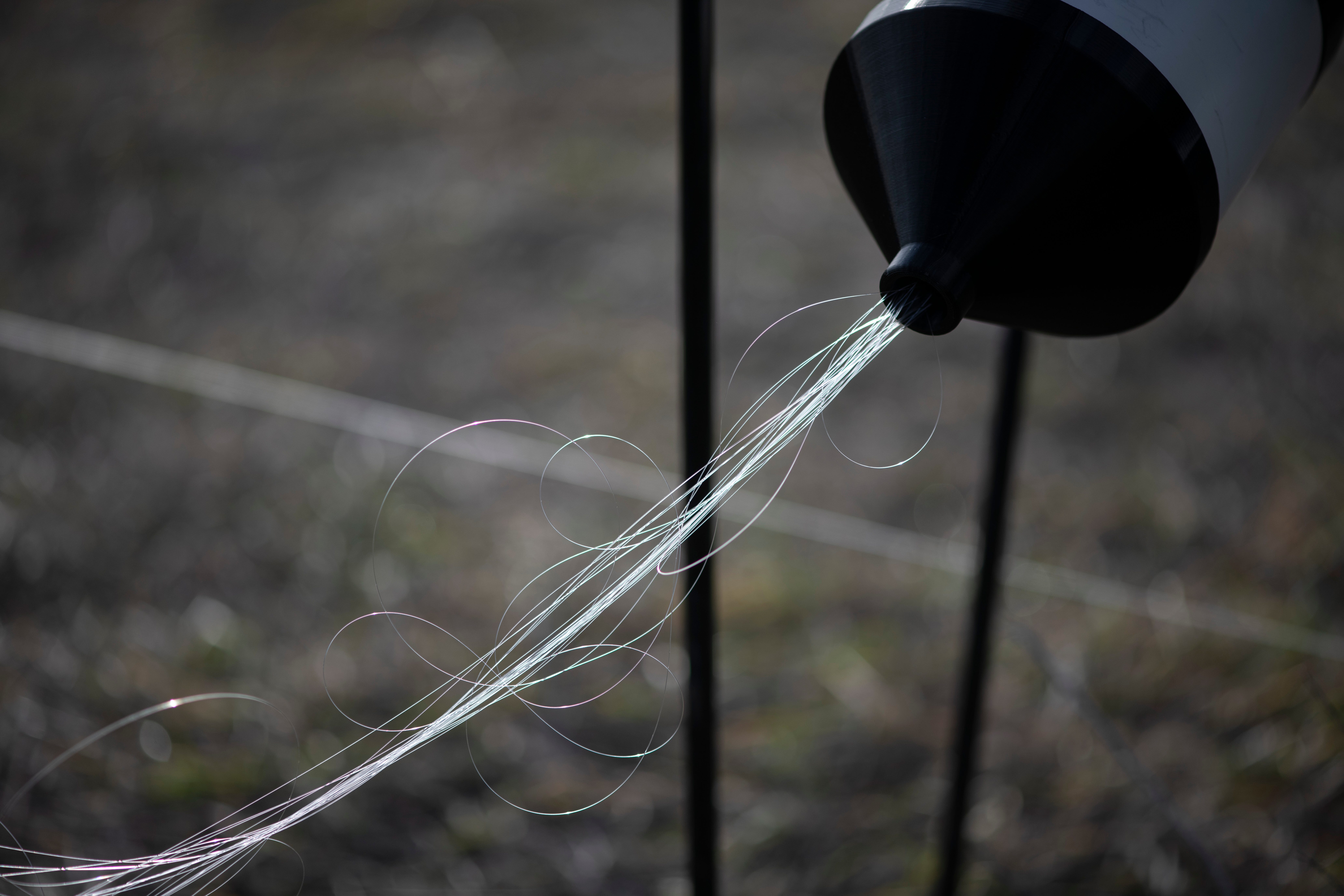 Fiber-optic wires can be seen connected to a drone during a test flight in the Kyiv region in December.