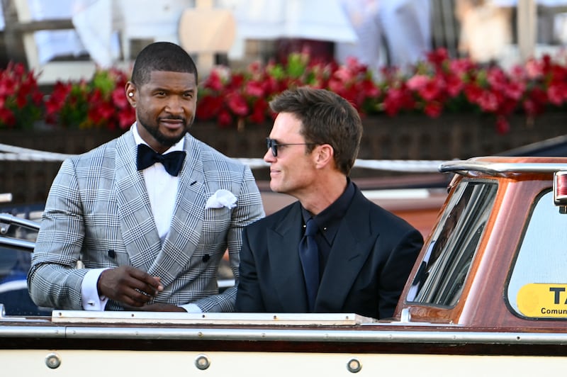 Usher and Tom Brady were photographed as they left the Gritti Palace Hotel on Friday.