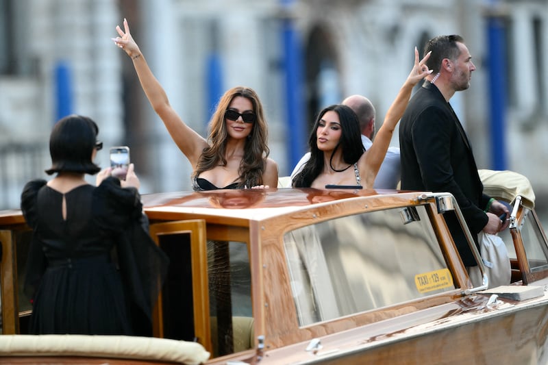 US television personality Kris Jenner takes pictures of US Khloe Kardashian (C) and US reality TV personality Kim Kardashian on a taxi boat.