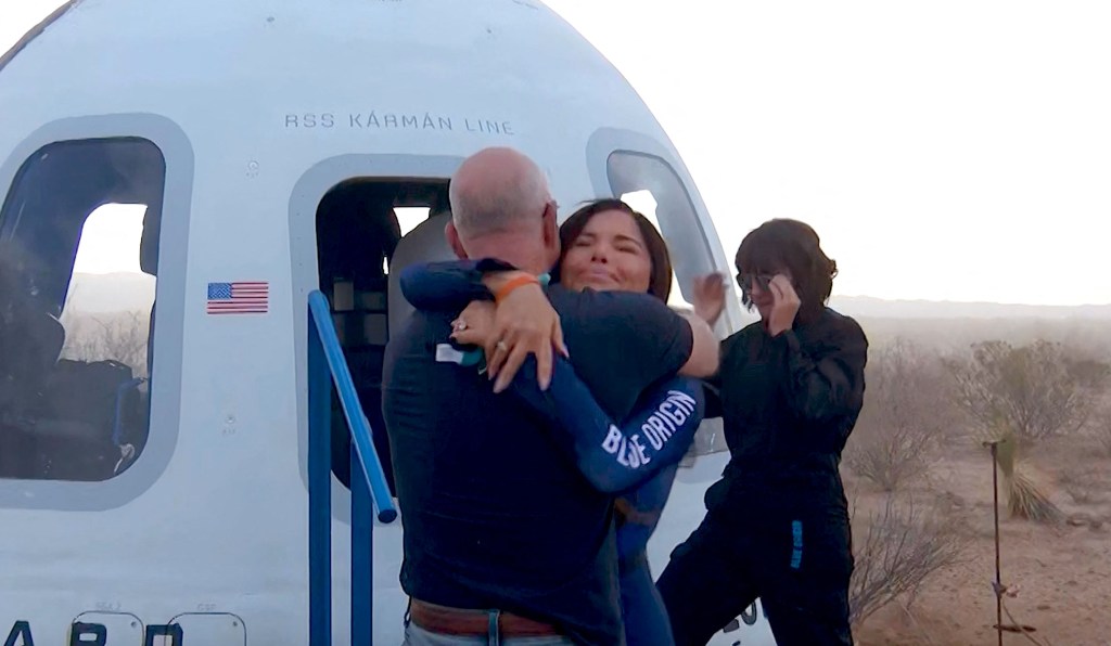 Lauren Sánchez hugging Jeff Bezos after her Blue Origin space flight.