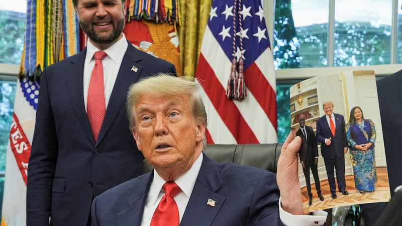 U.S. President Donald Trump presents a picture of himself with the Democratic Republic of the Congo's Foreign Minister Therese Kayikwamba Wagner and Rwanda's Foreign Minister Olivier Nduhungirehe