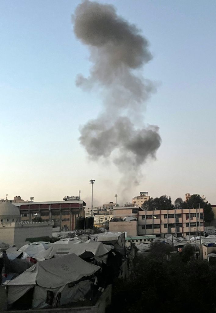 Smoke plume rising from a building in Gaza City after an Israeli air strike.